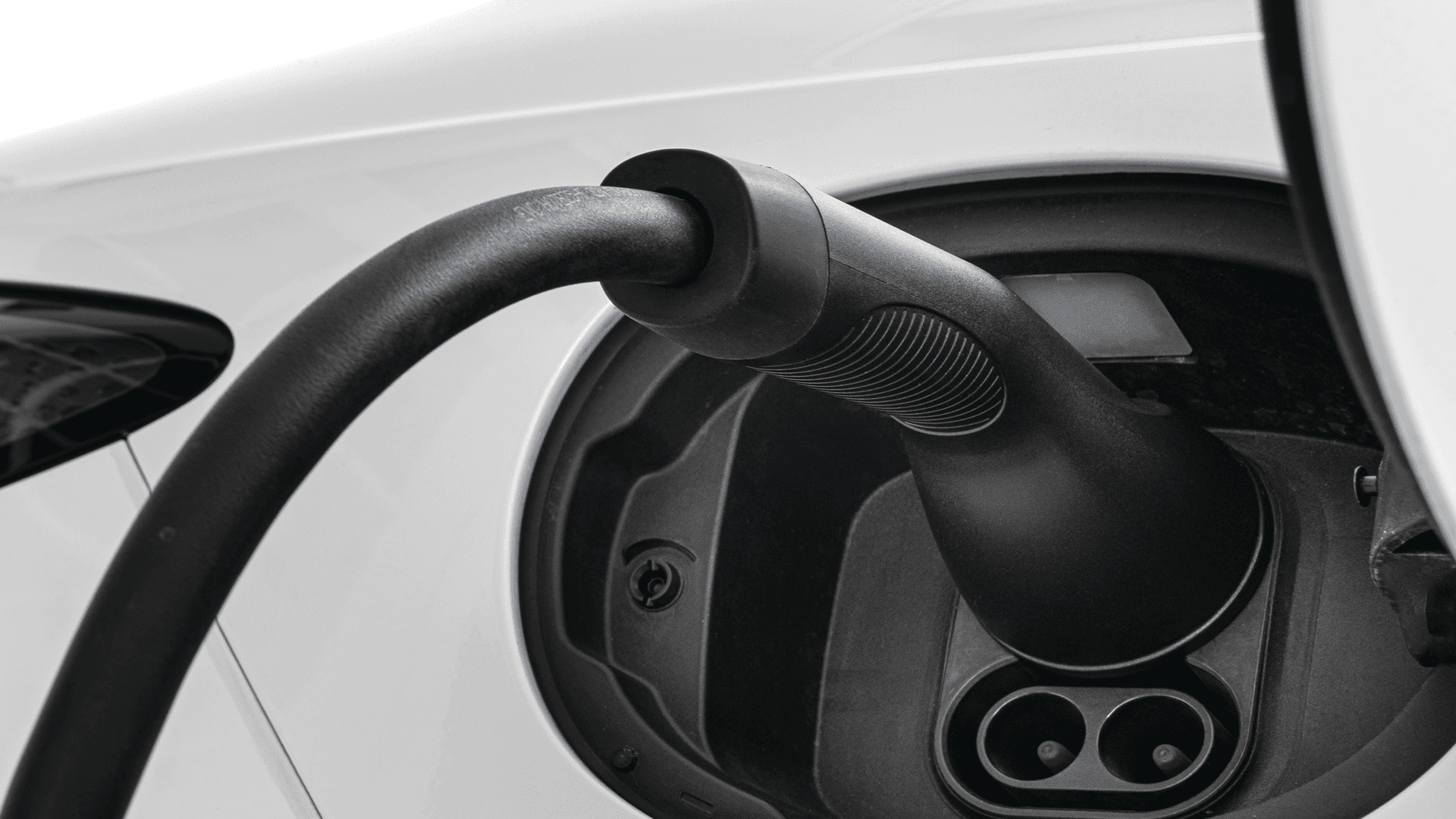 Electric vehicle plugged into a Level 2 home charging station